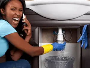 Emergency plumbing repair for a leaking sink drain under a bathroom vanity in Saint Louis, MO