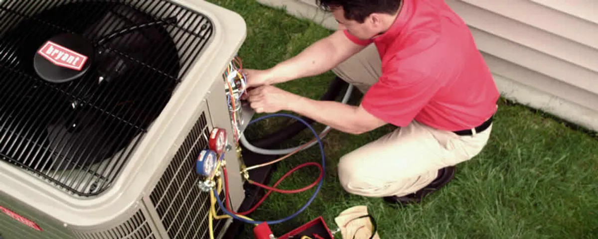 HVAC technician servicing an outdoor air conditioner unit in Saint Louis, MO