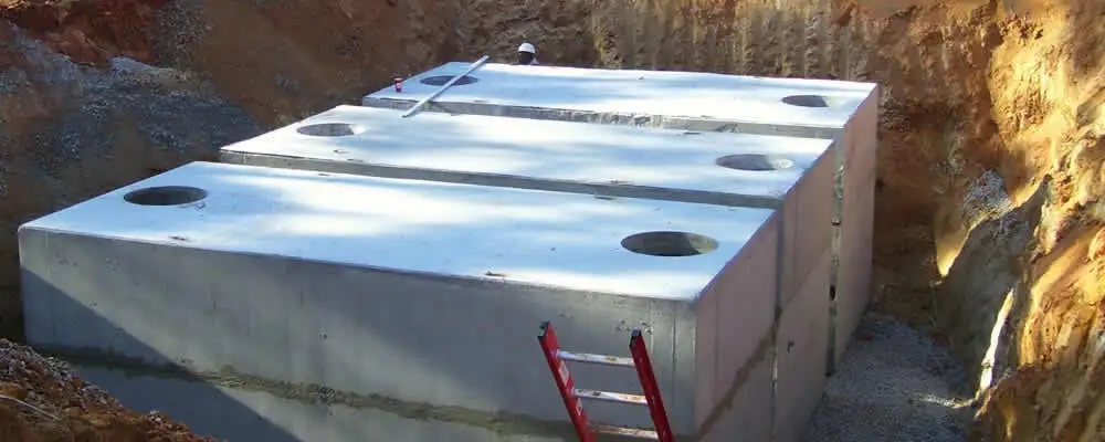 Septic tank installation site with a newly placed concrete tank in Saint Louis, MO